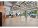 Spacious garage with overhead storage racks and an epoxy floor to keep your cars and belongings organized at 620 Ponce De Leon Dr, Tierra Verde, FL 33715