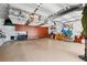 Spacious garage with epoxy floors, custom storage cabinets, and overhead racks at 620 Ponce De Leon Dr, Tierra Verde, FL 33715