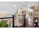 Elegant hallway with dark wood floors and a spiral staircase leads to bright, airy rooms at 620 Ponce De Leon Dr, Tierra Verde, FL 33715