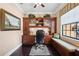 Well-lit home office with a built-in desk, cabinets, and window bench at 620 Ponce De Leon Dr, Tierra Verde, FL 33715