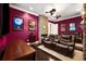 Movie room featuring reclining chairs, a stacked stone fireplace, and movie posters at 620 Ponce De Leon Dr, Tierra Verde, FL 33715