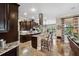 Beautiful kitchen with dark wood cabinetry, granite countertops, a central island, and stainless steel appliances at 620 Ponce De Leon Dr, Tierra Verde, FL 33715