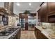 Modern kitchen featuring stainless steel appliances, granite countertops, and sleek, dark wood cabinetry at 620 Ponce De Leon Dr, Tierra Verde, FL 33715