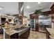 Open concept kitchen featuring stainless appliances, island cooktop, and adjacent living area at 620 Ponce De Leon Dr, Tierra Verde, FL 33715