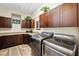 Laundry room with dark wood cabinets and a sink at 620 Ponce De Leon Dr, Tierra Verde, FL 33715