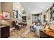 Spacious living room with marble floors, comfortable seating, and a staircase with dark wood and white banisters at 620 Ponce De Leon Dr, Tierra Verde, FL 33715