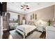 Bedroom with a cozy seating area, white furniture, and large window with natural light at 620 Ponce De Leon Dr, Tierra Verde, FL 33715