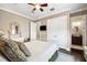 Main bedroom featuring dark hardwood floors, ensuite bath, and walk in closet at 620 Ponce De Leon Dr, Tierra Verde, FL 33715