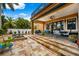 Charming covered patio with comfortable seating, dining area and a view of the refreshing pool at 620 Ponce De Leon Dr, Tierra Verde, FL 33715