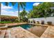 Outdoor pool surrounded by lush landscaping and a white fence at 620 Ponce De Leon Dr, Tierra Verde, FL 33715