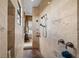 Modern shower with travertine tile and updated fixtures for a spa-like experience at 620 Ponce De Leon Dr, Tierra Verde, FL 33715