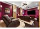 Home theater with reclining leather chairs, tiered floor, and custom lighting at 620 Ponce De Leon Dr, Tierra Verde, FL 33715