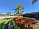 Entrance to Crescent Oaks with palm trees and vibrant flowers at 3181 Sterling St, Tarpon Springs, FL 34688