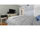 Serene bedroom with wood floors, a comfortable bed, and ensuite bathroom access, offering a private space at 6201 2Nd E St # 73, St Pete Beach, FL 33706