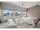 Bright and airy bedroom with twin beds, ceiling fan and a large window offering serene views at 6201 2Nd E St # 73, St Pete Beach, FL 33706