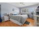 Comfortable bedroom with hardwood floors, a queen-sized bed, shutters, and a ceiling fan, providing a relaxing retreat at 6201 2Nd E St # 73, St Pete Beach, FL 33706