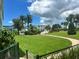 Expansive lawn of a well-maintained community with palm trees and lush landscaping at 6201 2Nd E St # 73, St Pete Beach, FL 33706