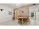 Cozy dining area featuring a round wooden table and chairs, complemented by decor and natural light at 6201 2Nd E St # 73, St Pete Beach, FL 33706