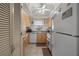 Bright kitchen featuring light wood cabinets, tile floors, and white appliances at 6201 2Nd E St # 73, St Pete Beach, FL 33706