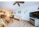 Living room with wicker furniture, wood floors and adjacent dining area at 12760 Indian Rocks Rd # 1036, Largo, FL 33774