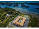 Aerial view showing building, pool, tennis court, and surrounding waterways at 12760 Indian Rocks Rd # 1036, Largo, FL 33774