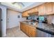 Kitchen with light wood cabinets, stainless steel appliances and a view to the dining area at 12760 Indian Rocks Rd # 1036, Largo, FL 33774