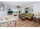 Bright living room with wicker furniture and wood-look floors at 12760 Indian Rocks Rd # 1036, Largo, FL 33774