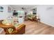 Bright living room with wicker furniture and wood-look floors at 12760 Indian Rocks Rd # 1036, Largo, FL 33774
