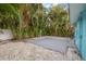 Lush backyard with tropical plants, a gravel bed, and a concrete slab at 6465 30Th S St, St Petersburg, FL 33712