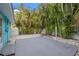 Backyard features concrete patio, white stone landscaping, and mature tropical trees at 6465 30Th S St, St Petersburg, FL 33712
