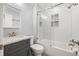 Bathroom features a subway tiled shower with glass door, gray vanity with marble countertop at 6465 30Th S St, St Petersburg, FL 33712