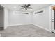 Bedroom with light grey wood-look floors, white trim and an exit door at 6465 30Th S St, St Petersburg, FL 33712