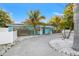 Charming exterior view of the home with a spacious driveway and tropical landscaping at 6465 30Th S St, St Petersburg, FL 33712
