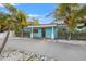 Inviting single-story home with a vibrant blue exterior, well-maintained landscaping, and a spacious driveway at 6465 30Th S St, St Petersburg, FL 33712