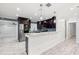 Bright kitchen with stainless steel appliances, dark cabinets, marble countertops, and shiplap accent wall at 6465 30Th S St, St Petersburg, FL 33712