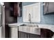 Close up shot of the farmhouse stainless steel kitchen sink with modern faucet and window with white shutters at 6465 30Th S St, St Petersburg, FL 33712