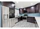 A modern kitchen featuring stainless steel appliances, blue backsplash, and dark wood cabinets at 6465 30Th S St, St Petersburg, FL 33712