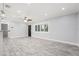 Spacious living room with a ceiling fan, and light gray wood-look floors at 6465 30Th S St, St Petersburg, FL 33712