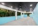 Expansive covered patio with a dark ceiling, white columns, and an inviting outdoor living space at 6465 30Th S St, St Petersburg, FL 33712
