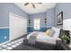 Cozy bedroom with gray bedding and window shutters at 667 Richmond Close, Tarpon Springs, FL 34688