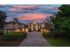 Elegant home at dusk with a beautiful sunset in the background at 667 Richmond Close, Tarpon Springs, FL 34688