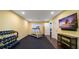 Well-equipped home gym featuring treadmill, weights, and TV at 667 Richmond Close, Tarpon Springs, FL 34688