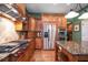 Bright kitchen with stainless steel appliances and wood cabinets at 667 Richmond Close, Tarpon Springs, FL 34688