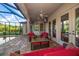 Covered lanai with comfortable seating and pool view at 667 Richmond Close, Tarpon Springs, FL 34688
