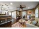 Open living room with kitchen, hardwood floors, and comfy seating at 667 Richmond Close, Tarpon Springs, FL 34688