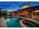 Luxury pool and spa with covered patio and home views at 667 Richmond Close, Tarpon Springs, FL 34688