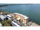 Aerial view of waterfront condo building with parking and beautiful water views at 9 Haig Pl # 806, Dunedin, FL 34698