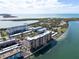 Aerial view of waterfront condo building with parking and water access at 9 Haig Pl # 806, Dunedin, FL 34698