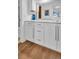 Bathroom with white cabinets and wood-look floors at 9 Haig Pl # 806, Dunedin, FL 34698