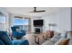 Living room with ocean view, fireplace, and comfy seating at 9 Haig Pl # 806, Dunedin, FL 34698